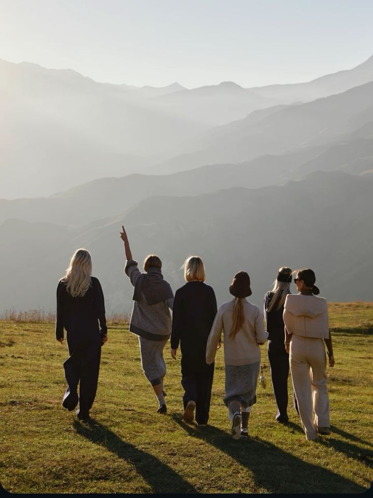 A diverse group of community members walking together on an Auckland coastal pathway